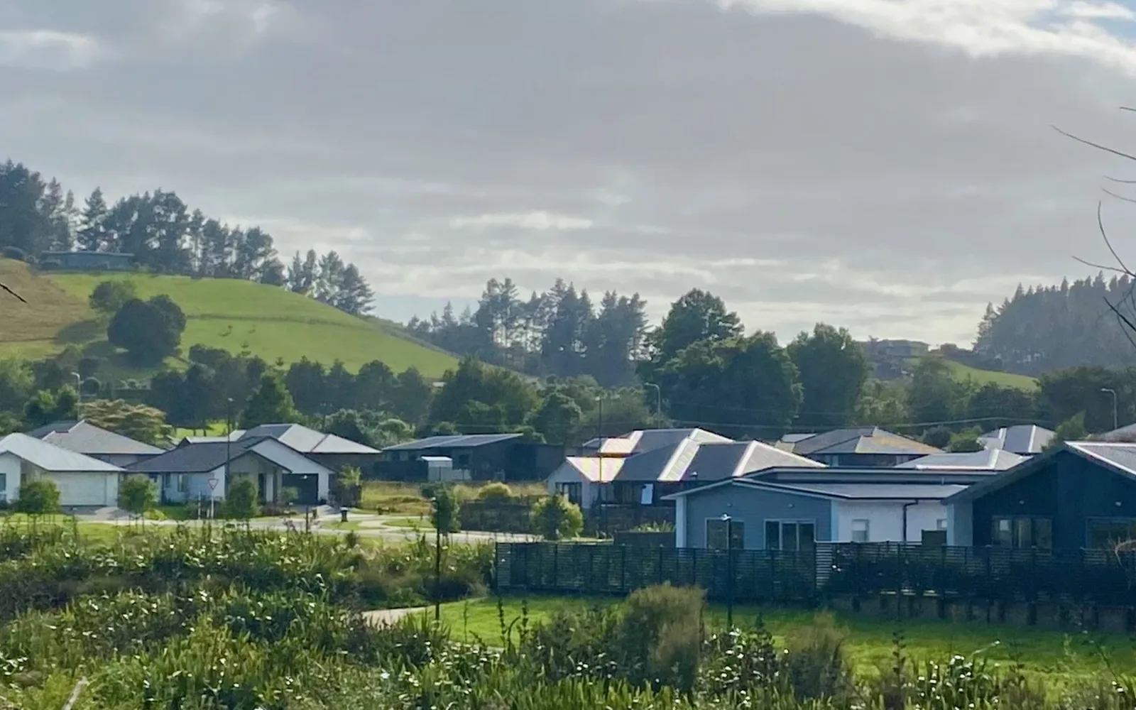 New suburban housing development with finished homes on cleared residential lots