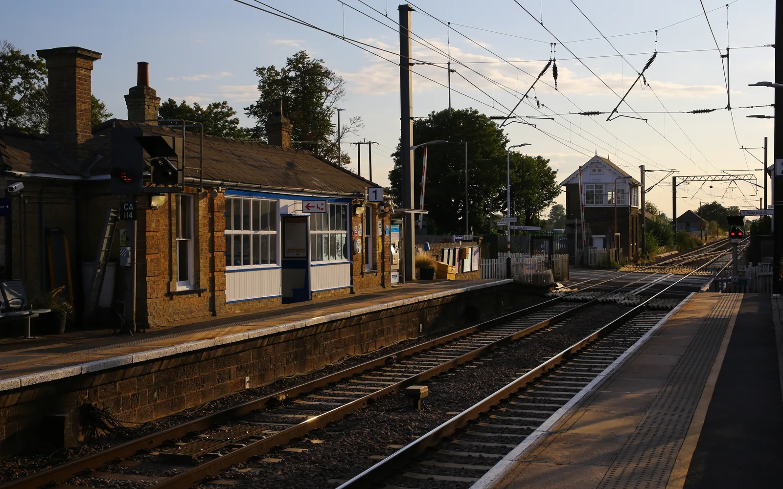 Foxton Railway Station building with platform and railroad tracks extending into the distance